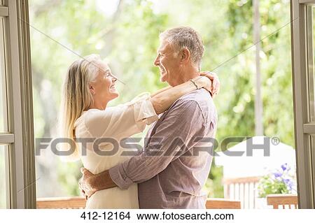 Senior couple hugging in doorway View Large Photo Image Picture - Senior couple hugging in doorway. Fotosearch