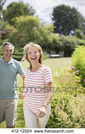 Senior couple running in backyard View Large Photo Image Picture - Senior couple running in backyard. Fotosearch