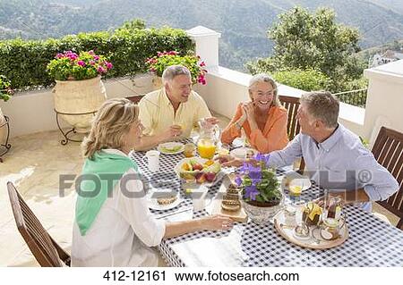 Senior couples enjoying breakfast on balcony View Large Photo Image Stock Image - Senior couples enjoying breakfast on balcony. Fotosearch