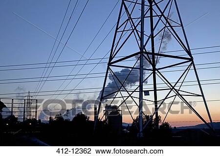 Stock Image - Silhouette of power lines and pylons at sunrise. Fotosearch