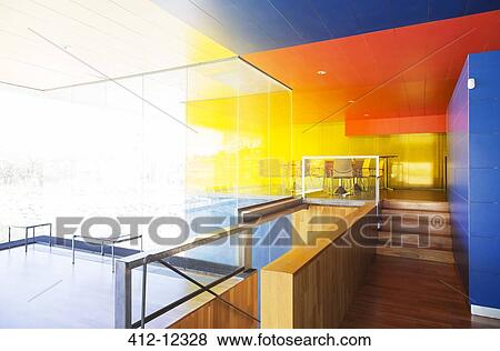 Stock Photo - Sun shining through windows in bright office. Fotosearch