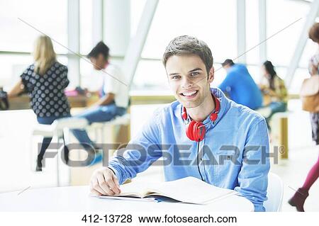Stock Photo - University student smiling in cafe. Fotosearch
