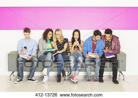 University students sitting on bench View Large Photo Image Stock Photograph - University students sitting on bench. Fotosearch