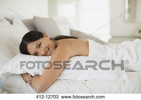 Woman hugging pillow on bed View Large Photo Image Stock Image - Woman hugging pillow on bed. Fotosearch