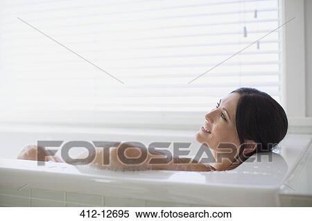 Stock Photography - Woman relaxing in bubble bath. Fotosearch