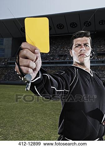 Referee flashing yellow card on soccer field View Large Photo Image Stock Photo - Referee flashing yellow card on soccer field. Fotosearch