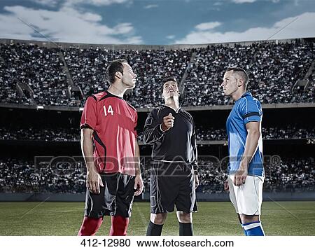 Stock Image - Referee tossing coin in soccer game. Fotosearch