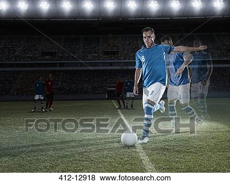 Soccer player approaching ball on field View Large Photo Image Stock Photo - Soccer player approaching ball on field. Fotosearch