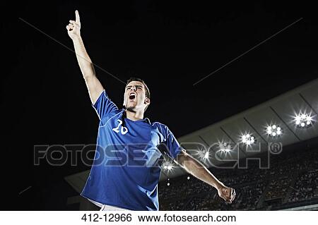 Soccer player cheering in stadium View Large Photo Image Stock Photograph - Soccer player cheering in stadium. Fotosearch