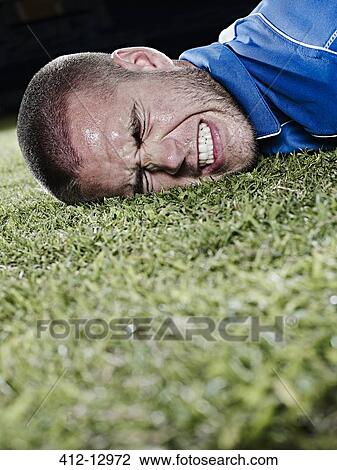 Soccer player falling on field View Large Photo Image Stock Image - Soccer player falling on field. Fotosearch