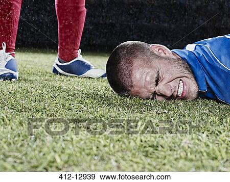 Soccer player falling on field View Large Photo Image Stock Photo - Soccer player falling on field. Fotosearch
