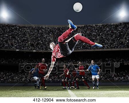 Soccer player kicking ball on field View Large Photo Image Picture - Soccer player kicking ball on field. Fotosearch
