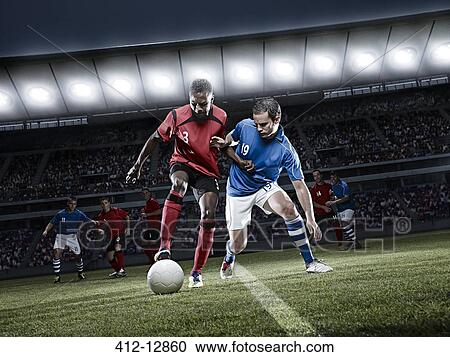 Soccer players chasing ball on field View Large Photo Image Stock Image - Soccer players chasing ball on field. Fotosearch