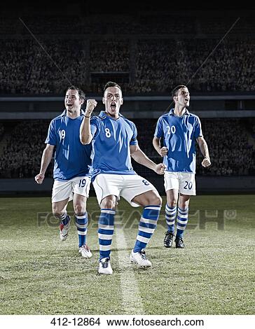 Soccer players cheering on field View Large Photo Image Picture - Soccer players cheering on field. Fotosearch