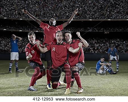 Soccer players cheering on field View Large Photo Image Stock Image - Soccer players cheering on field. Fotosearch