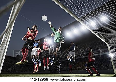 Soccer players defending goal View Large Photo Image Stock Photo - Soccer players defending goal. Fotosearch