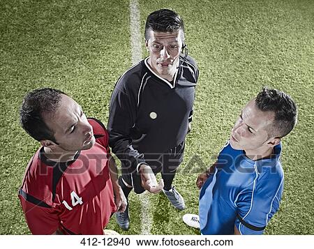 Stock Image - Soccer players facing each other on field. Fotosearch