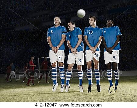 Stock Photo - Soccer players jumping on field. Fotosearch