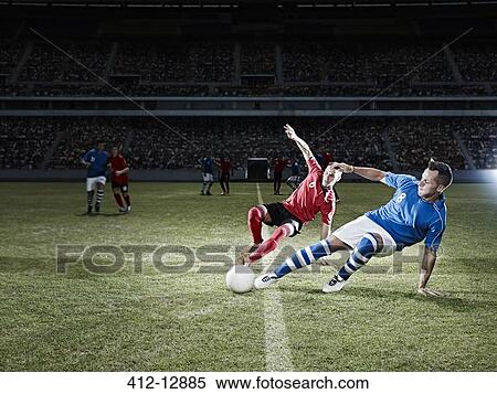 Soccer players kicking for ball on field View Large Photo Image Stock Photography - Soccer players kicking for ball on field. Fotosearch