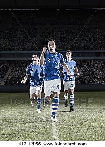 Stock Photography - Soccer players running on field. Fotosearch