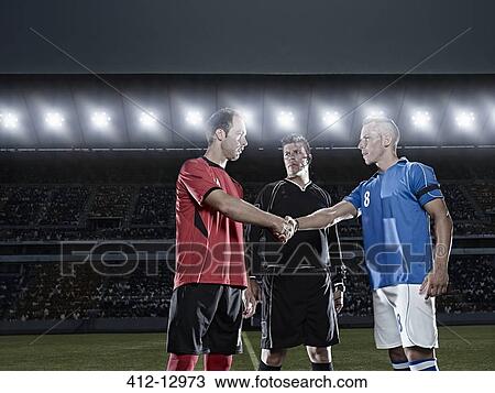 Stock Image - Soccer players shaking hands on field. Fotosearch