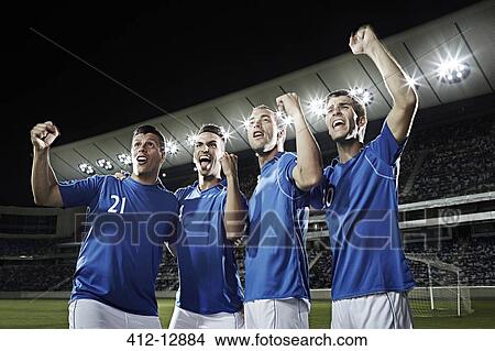 Picture - Soccer team cheering on field. Fotosearch
