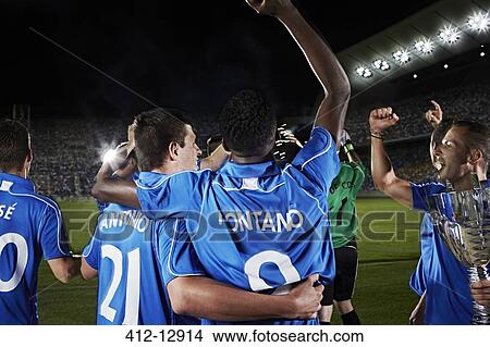 Picture - Soccer team cheering on field. Fotosearch