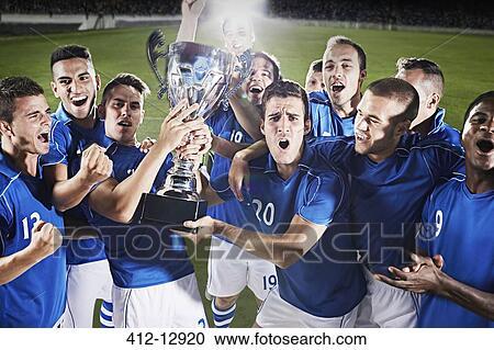 Soccer team cheering with trophy on field View Large Photo Image Stock Image - Soccer team cheering with trophy on field. Fotosearch