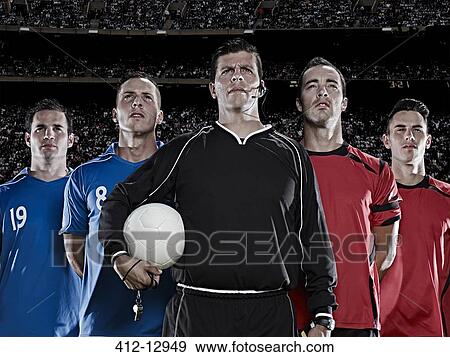 Stock Photo - Soccer teams and referee standing in stadium. Fotosearch