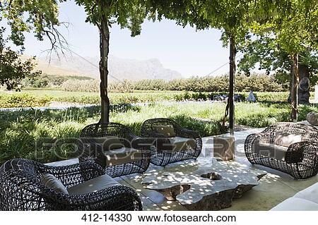 Armchairs and sofa on modern patio overlooking vineyard View Large Photo Image Stock Image - Armchairs and sofa on modern patio overlooking vineyard. Fotosearch