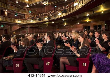 Stock Image - Audience applauding in theater. Fotosearch