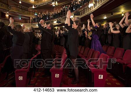 Stock Image - Audience applauding in theater. Fotosearch