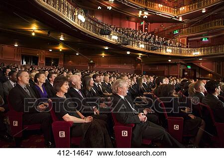 Stock Photo - Audience watching performance in theater. Fotosearch