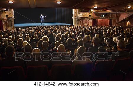 Audience watching performer on stage in theater View Large Photo Image Stock Image - Audience watching performer on stage in theater. Fotosearch