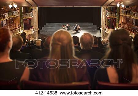 Audience watching quarter perform on stage in theater View Large Photo Image Stock Photo - Audience watching quarter perform on stage in theater. Fotosearch