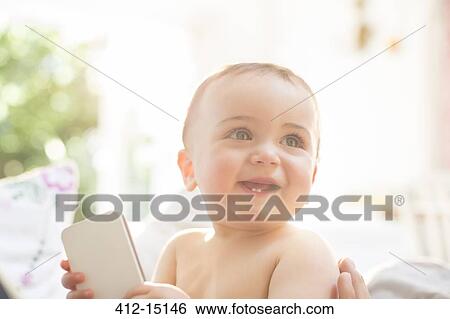 Baby boy playing with cell phone View Large Photo Image Stock Photograph - Baby boy playing with cell phone. Fotosearch