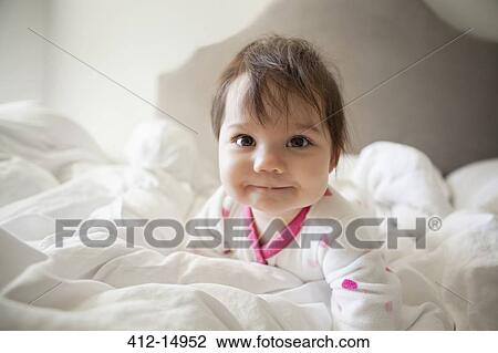 Baby girl crawling in bedsheets View Large Photo Image Stock Image - Baby girl crawling in bedsheets. Fotosearch