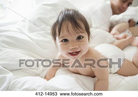 Baby girl crawling in bedsheets View Large Photo Image Stock Image - Baby girl crawling in bedsheets. Fotosearch