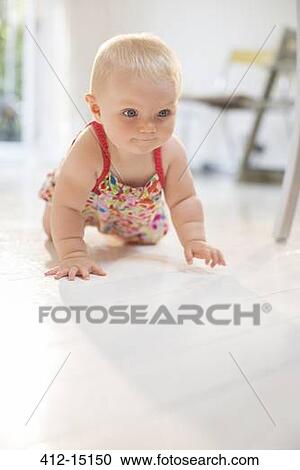 Baby girl crawling on floor View Large Photo Image Stock Image - Baby girl crawling on floor. Fotosearch
