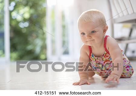 Baby girl crawling on floor View Large Photo Image Stock Image - Baby girl crawling on floor. Fotosearch