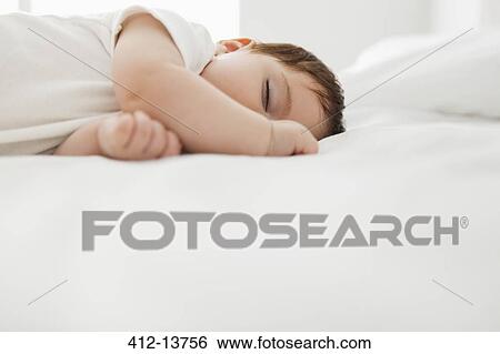 Baby girl sleeping on bed View Large Photo Image Stock Photograph - Baby girl sleeping on bed. Fotosearch