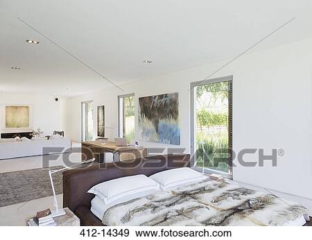 Bed in modern living space View Large Photo Image Stock Photo - Bed in modern living space. Fotosearch