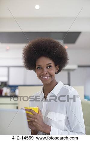 Businesswoman drinking coffee in kitchen View Large Photo Image Stock Photo - Businesswoman drinking coffee in kitchen. Fotosearch