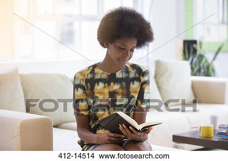 Businesswoman reading book on sofa View Large Photo Image Picture - Businesswoman reading book on sofa. Fotosearch