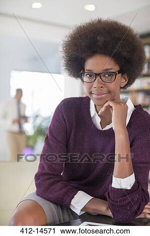 Businesswoman smiling in living room View Large Photo Image Stock Image - Businesswoman smiling in living room. Fotosearch