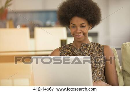 Stock Photo - Businesswoman using laptop. Fotosearch