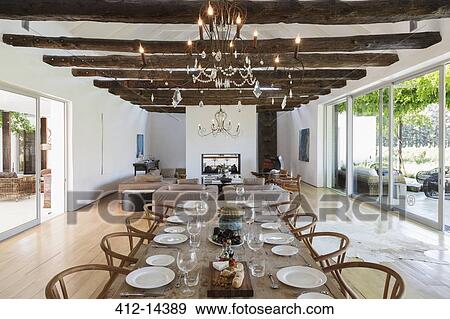 Chandelier over dining table in luxury house View Large Photo Image Stock Photo - Chandelier over dining table in luxury house. Fotosearch
