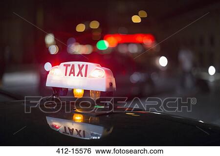 Stock Photograph - Close up of illuminated Parisian taxi light, Paris, France. Fotosearch