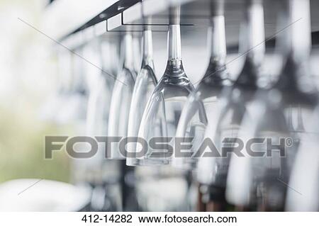 Stock Image - Close up of wine glasses in bar. Fotosearch