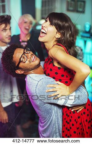 Stock Photo - Couple dancing together at party. Fotosearch